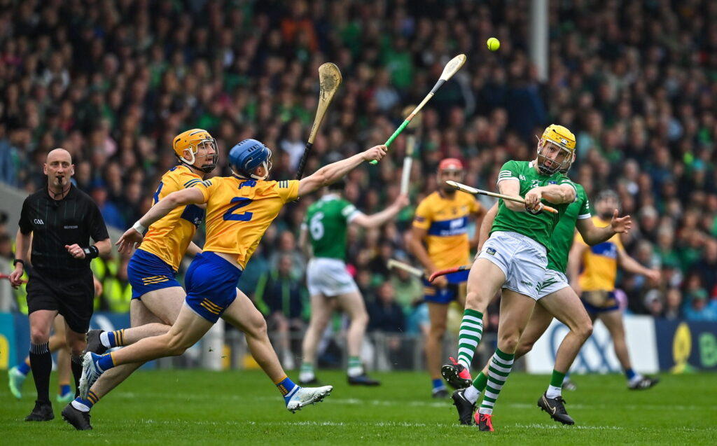 5 June 2022; Séamus Flanagan of Limerick scores a point despite the best efforts of David Fitzgerald and Rory Hayes of Clare during the Munster GAA Hurling Senior Championship Final match between Limerick and Clare at FBD Semple Stadium in Thurles, Tipperary. Photo by Brendan Moran/Sportsfile